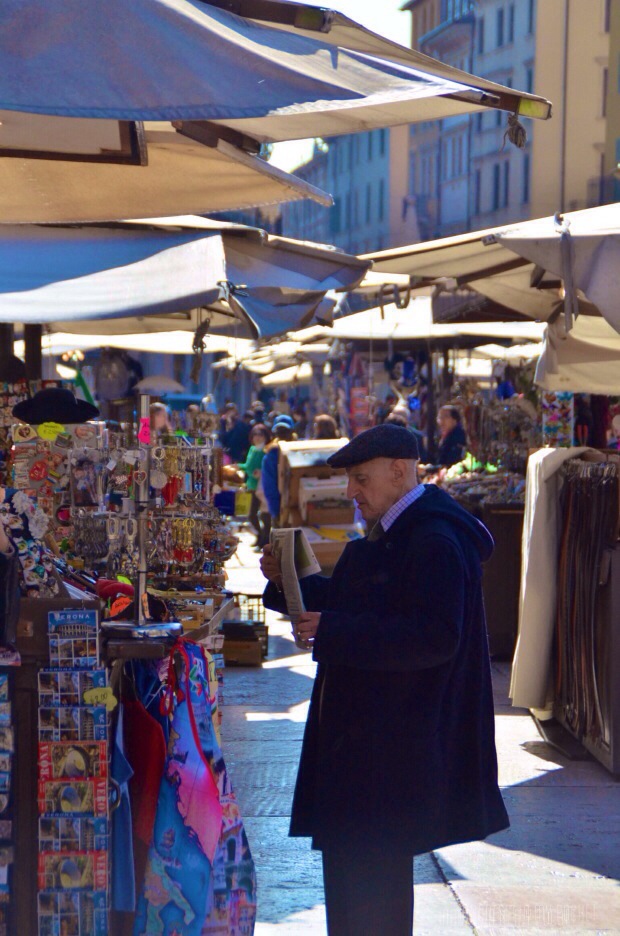 An old man reading newspaper in Verona
